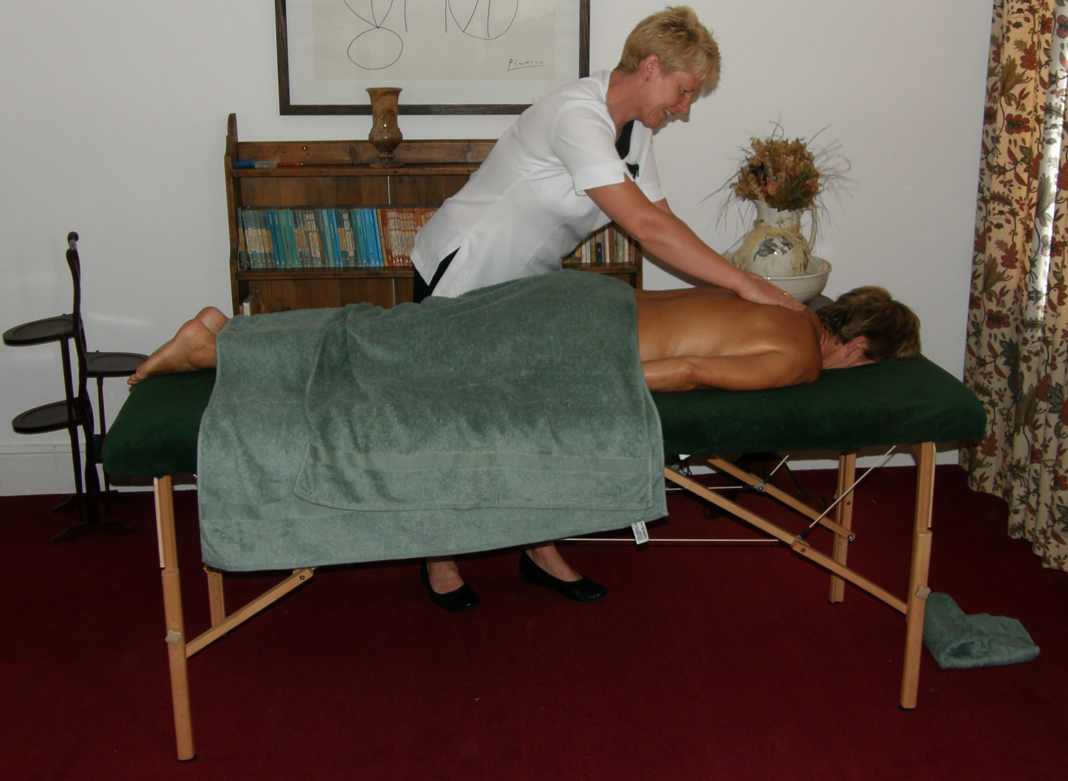 Sally massaging a clents back using effleurage strokes.